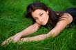 © Designpics - Beautiful young brunette rests on the green grass