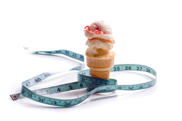 Canvas Print - Concept image of a diet featuring an ice cream cone with strawberry ice cream and a measuring tape shot on white