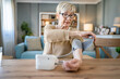 © Miljan Živković - Senior caucasian woman check blood pressure measure device on hand