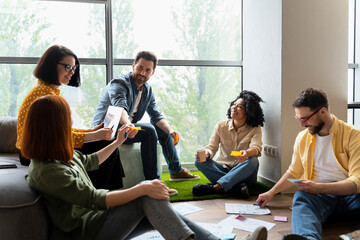 Wall Mural - Group of smiling multiracial business people, colleagues talking, planning startup, sharing ideas, cooperation, working together in modern office. Meeting, teamwork, scrum, agile, successful business