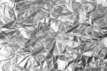 Crumpled silver foil as background, closeup view