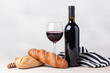 Red wine, bread and striped textile, french cliche. Generative AI