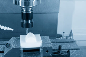 Wall Mural - The  CNC milling machine cutting the nylon 6 material part with ball end mill tool.