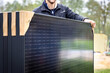 Person holding a set of several new solar panels