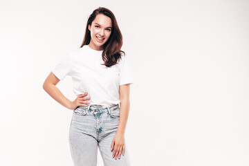 Wall Mural - Young beautiful woman. Trendy carefree model in casual summer white T-shirt and blue jeans. Positive female isolated on white in studio. Cheerful and happy. Copy space, mockup