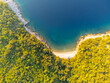 Rocky cliffs with small beach and blue sea on sunny summer day. Istria adriatic coastline, Croatia