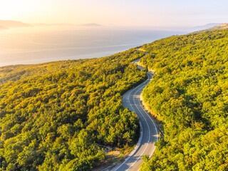 Winding coastal road, rocky cliffs and blue sea in sunny morning. Istria, Croatia