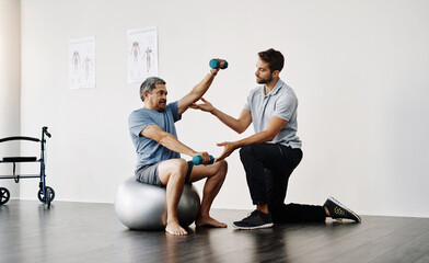 Dumbbells, physiotherapy and rehabilitation with doctor and patient for help, training and stretching. Healthcare, wellness and healing with old man and expert for consulting, muscle and exercise