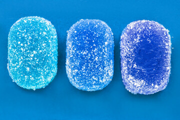 Wall Mural - Jelly candies on blue background