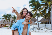 Hispanic Young Couple In Love Man And Woman Having Fun On Caribbean Beach In Holidays Or Vacations In Mexico Latin America