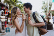 © Marcos - hispanic young couple eating ice cream on vacations or holidays in Mexico Latin America, Caribbean and tropical destination