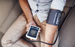 © Camerene Pendl/peopleimages.com - Hypertension, machine and man test blood pressure in a home sofa or living room for medical or health exam. Monitor, reading and person in a lounge equipment for chronic disease due to stress