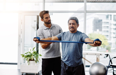 Canvas Print - Physiotherapy, rehabilitation and band with old man and doctor for training, stretching and injury. Medical, healing and healthcare with physiotherapist and patient for consulting, help and fitness