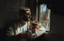 Father And Child Sitting By The Window In Train. Travel Concept