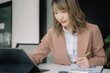 © NINENII - Business concepts, business women working in the work area with tablet and data sheets at the desk.