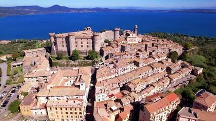 Wall Mural - Scenic lake and beautiful medieval castle  Bracciano. Italy. lazio region. Aerial drone view of old town and fortress with lake at background