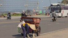 Janitor Cleans The City From Garbage Using A Big Cart