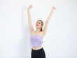 © Bangkok Click Studio - Portrait studio isolated cutout shot of Millennial Asian beautiful pretty cheerful female model in tube cropped top casual shirt holding hands up closed eyes stretching arms on white background