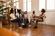 © PintoArt - people with addiction sharing mental health problems with a group in a meeting, talking to a therapist. People discussing depression and rehabilitation in therapy sessions.