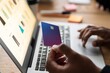 © Studio Marmellata - Unrecognizable male using modern laptop while entering credit card credentials into computer during online shopping