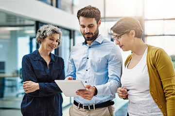 Business people, tablet and meeting in team collaboration for planning, idea or strategy at office. Group of employee workers on technology in teamwork for research, project plan or networking