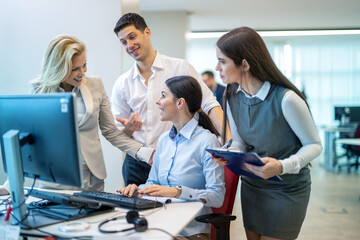 Wall Mural - Group of beautiful business people gathered together at a table building a strong financial plan defining financial goals and reviewing company progress.