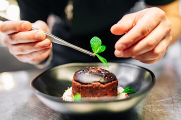 chef decorated Basque cheesecake with Chocolate and cream in bowl on kitchen