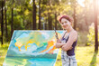 © Austockphoto - Smiling portrait of happy young woman artist in forest clearing with beginning of painting