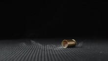 Slow Motion Shot Of Empty Bullet Shells Fall Down On A Black Background. 
