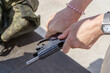 © Dmitry - A woman reloads a combat pistol. Firearms training. Close-up. unrecognizable person