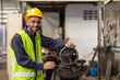 © Quality Stock Arts - Hispanic latin indian male engineer worker happy smile enjoy working in metal lathe factory