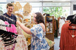 © Austockphoto - Young person with a disability browsing through dresses in a shop