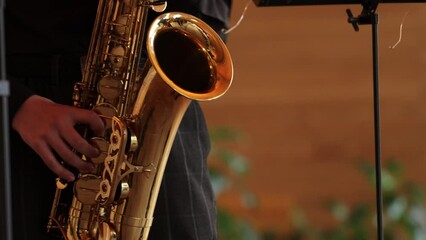 Poster - saxophonist in black suit playing the saxophone
