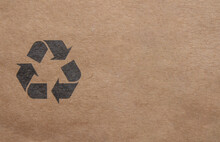 Recycle Symbol On Cardboard Paper Background With Copy Space For Text.