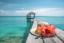 Straw Hat With Tropical Flowers In Pink And Orange On A Dock Over The Caribbean Sea