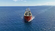 © aerial-drone - Aerial drone photo of huge crude oil tanker assisted by tug boat cruising open ocean deep blue sea