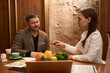 © Svitlana - Male and nutritionist discussing products at table