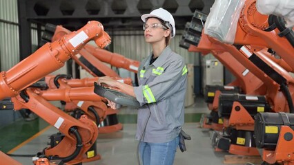 Wall Mural - Maintenance engineer worker working with robotic machine at factory