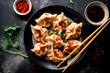 Dumplings gyoza jiaozi steamed on a white plate with soy sauce. Generative AI	