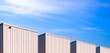 © Prapat - Panoramic view of industrial corrugated metal Warehouse Buildings group against blue Sky in perspective side view