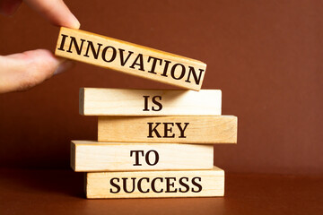 Wall Mural - Wooden blocks with words 'Innovation is key to success'.