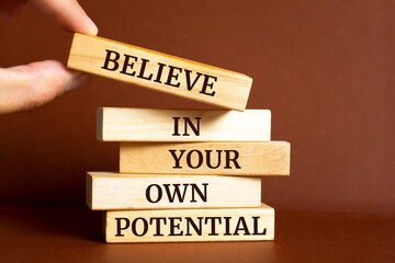 Wall Mural - Wooden blocks with words 'Believe in your own potential'. Motivation Quote
