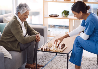 Canvas Print - Women, chess and nurse with a senior patient, retirement home and happiness with healthcare. Female person, medical professional and mature lady with employee, nursing and care with games and relax