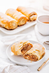 Wall Mural - Homemade apple strudel with cinnamon, apple pie with cup of fruit tea