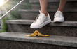 Foot stepping on a banana peel on steps