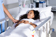© Wavebreak Media - Biracial female doctor and happy girl patient smiling in hospital bed