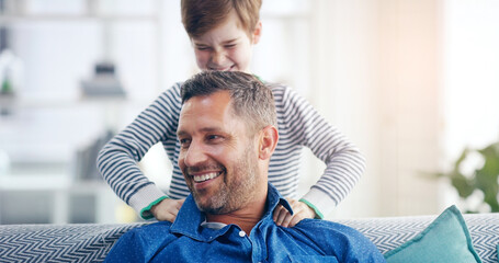 Sticker - Love, father and son happy smile in living room of their home with lens flare. Happiness or caring, family and male parent with child playing spending quality time or bonding together on couch