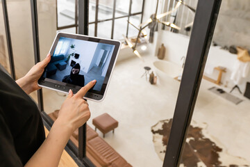 Woman monitoring modern cctv cameras on laptop indoors, closeup. Home security system