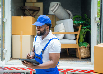 Poster - House moving service worker unloading boxes and checking list before sending them to the homeowner.