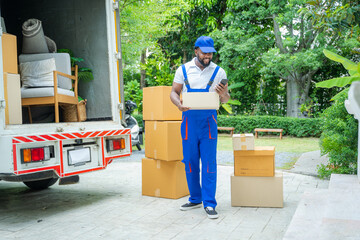Poster - Male movers unloading boxes from van into a new home,Removal company workers,Moving house day and real estate concept.